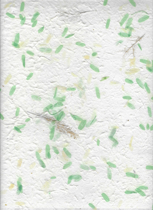 Carta di gelso artigianale con piccoli petali verdi su fondo bianco latte-avorio
