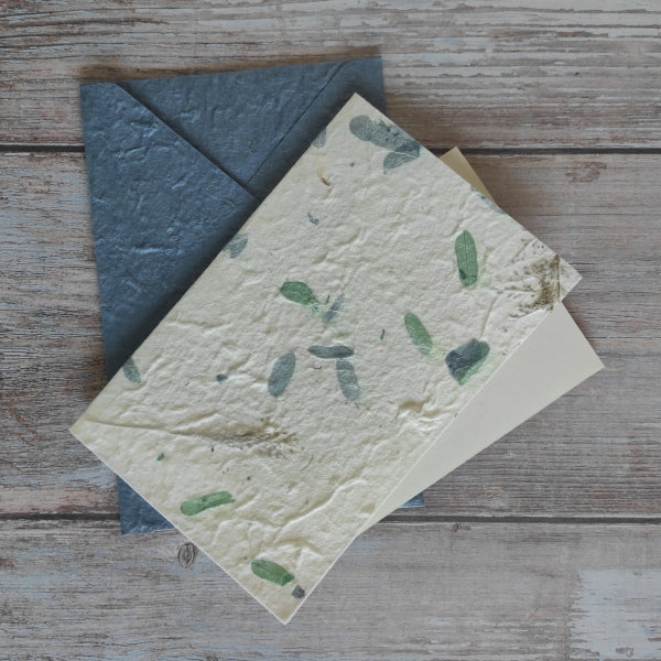 Set biglietto artigianale con carta di gelso “Petali blu e verdi”, foglio interno A5 e busta coordinata colore blu.